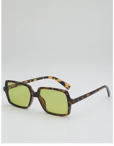 Detail of tortoise shell square sunglasses featuring vibrant yellow-green transparent lenses