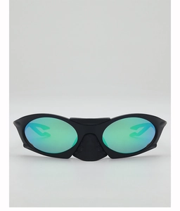 Close-up of matte black sports sunglasses featuring green mirrored lenses and ergonomic frame