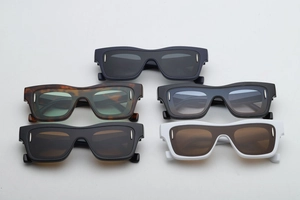Detail shot of rectangular sunglasses showing iconic oval metal rivets and five color variants