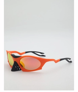 Close-up of orange aerodynamic sports sunglasses with red mirror coated lenses