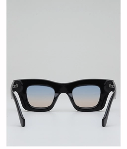 Detail of square vintage sunglasses with gradient blue lenses and glossy black frame