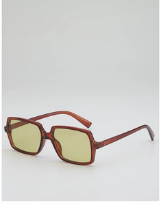 Detail view of tortoiseshell oversized sunglasses frame and yellow-green tinted lenses