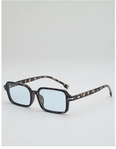 Macro shot of rectangular tortoiseshell sunglasses with light blue lenses and silver rivets