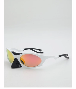 Detail view of white sports sunglasses with orange gradient lenses and futuristic nose guard
