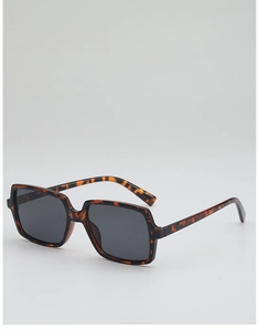 Macro detail of tortoiseshell pattern texture and polished finish on oversized sunglasses