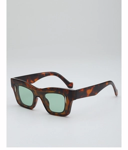 Detail of tortoise shell square sunglasses with vintage thick frames and green lenses