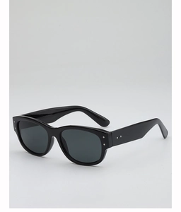 Close-up of retro black oval sunglasses with stylish silver rivet details on the frame