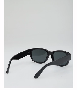 Detail of wide black sunglasses temples featuring two silver round rivets and glossy finish