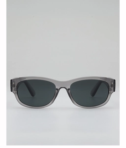 Detail of grey transparent oval frame with dark lenses and metal rivet accents