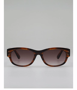 Detail of tortoise shell sunglasses with silver rivet accents and gradient lenses