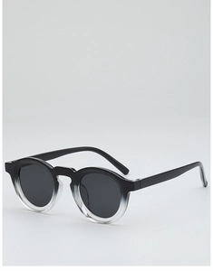 Detail view of retro round sunglasses featuring black to clear gradient frames and dark lenses