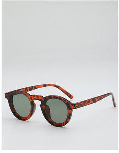 Detail of round tortoiseshell leopard print sunglasses with dark green lenses