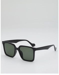 Detail view of large square black sunglasses frames with dark green lenses and wide temples