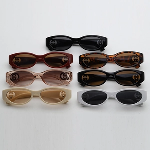 Selection of vintage oval sunglasses in black, tortoiseshell, and white fashionable shades