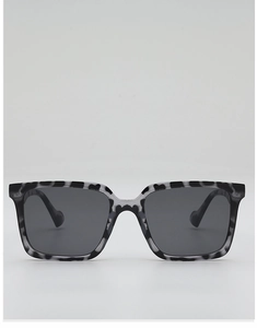 Detail of square oversized sunglasses with black and white tortoiseshell frame pattern