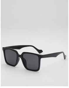 Close-up of classic black square oversized sunglasses with polished frames and dark lenses
