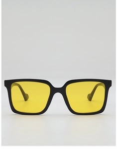 Detail of square black frame sunglasses with transparent yellow lenses in a close-up view