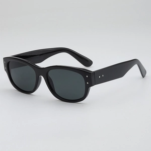 Retro small oval frame sunglasses with black glossy finish and silver rivet accents