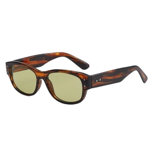 Retro tortoise shell sunglasses with yellow-green lenses and metal rivet details