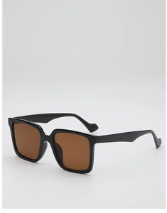 Detail of black oversized square sunglasses with brown lenses and wavy anti-slip temples