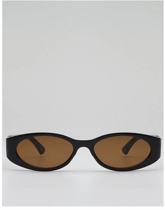 Close-up of retro oval sunglasses with thick black frames and tinted amber lenses