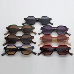 Multiple colorful geometric polygon sunglasses displayed in a stylish organized array