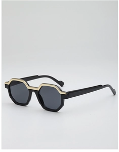 Detail of hexagonal sunglasses featuring a black frame and elegant gold metal trim accent