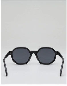 Detail of black polygonal sunglasses with dark grey lenses and metal rivet accents