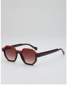 Detail of geometric two-tone sunglasses with bold red frame and brown gradient lenses