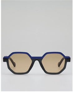 Detail of geometric polygonal sunglasses with blue and black frame and amber lenses
