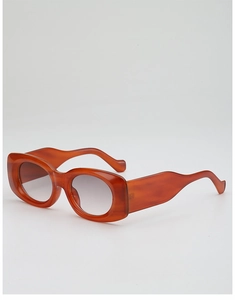 Side view of amber orange thick frame sunglasses with curved wavy temples and gradient lenses