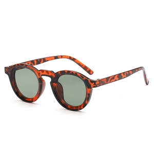 Retro round tortoise shell sunglasses with dark green lenses in a 45-degree side view