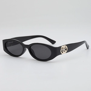Retro oval black sunglasses with gold metal logo detail and dark gray fashion lenses