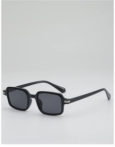 Detail of vintage black square sunglasses with metallic rivets and dark gray lenses