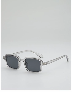 Detail of vintage square sunglasses featuring translucent smoke grey frames and silver accents
