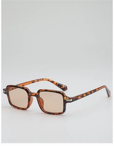 Detailed side view of vintage tortoise shell sunglasses with light brown lenses