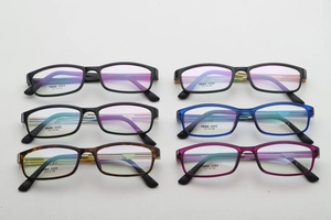 Macro shot of TR90-1152 square eyeglass frames in various colors like black and tortoiseshell