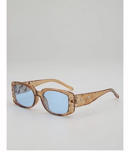 Detailed view of jelly tea frame sunglasses with geometric texture and blue tinted lenses