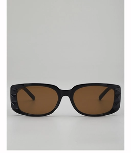 Close-up of black square sunglasses frame with unique 3D diamond texture and brown lenses