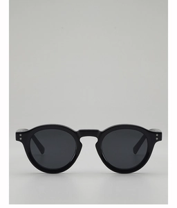 Close-up of retro black round frame sunglasses with silver stud accents and dark lenses