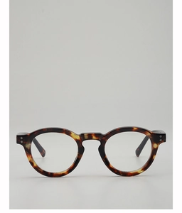 Detail of round tortoiseshell glasses frame with glossy finish and metal stud accents