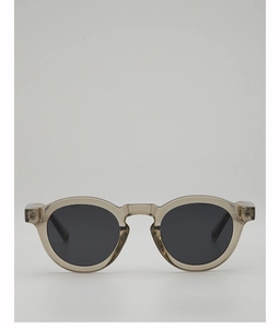 Detailed view of round vintage champagne translucent frames with dark gray lenses