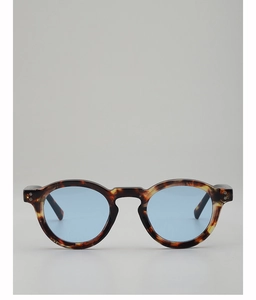 Close-up of retro round tortoiseshell sunglasses with light blue transparent lenses