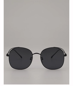 Close-up of black metal frame sunglasses with large round dark gradient lenses