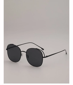 Detailed close-up of slim metal frames and double top line on black oversized sunglasses