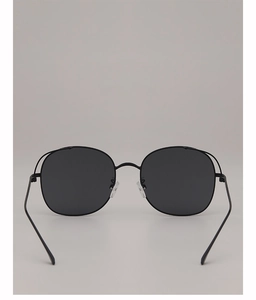 Detail view of round black metal sunglasses with grey lenses and soft silicone nose pads