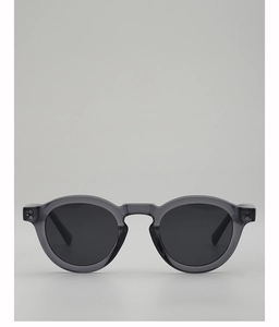 Detail of round grey translucent sunglasses with decorative metal rivets and black lenses