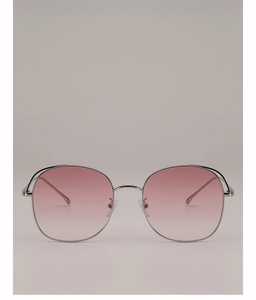 Detailed close-up of pink gradient lenses and silver metal frame of oversized sunglasses