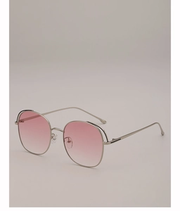 Detail of round oversized sunglasses with pink gradient lenses and slim silver metal frames