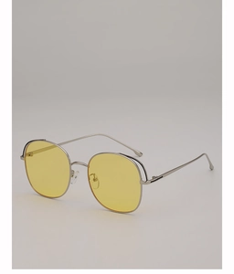 Detailed close-up of slim silver metal frame and yellow tinted lenses of sun glasses